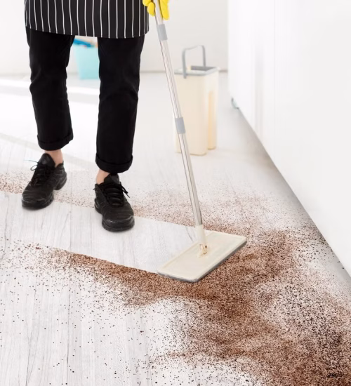 Person cleaning a dirty floor Person cleaning a dirty floor