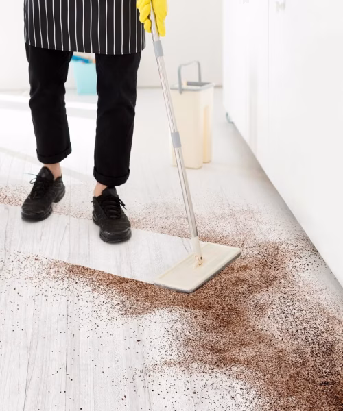 Person cleaning a dirty floor Person cleaning a dirty floor